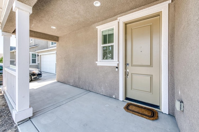 doorway to property with stucco siding and a patio