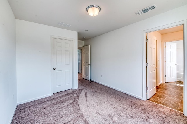 unfurnished bedroom featuring carpet and baseboards