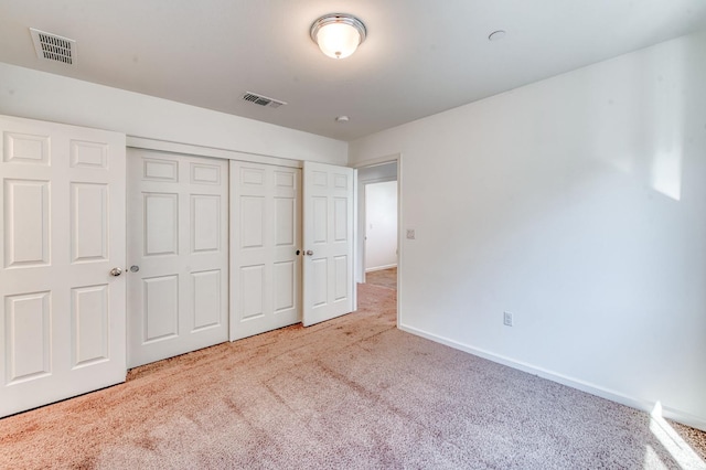 unfurnished bedroom with carpet flooring, a closet, and baseboards