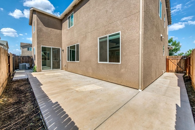 back of property featuring cooling unit, a patio, stucco siding, and a fenced backyard