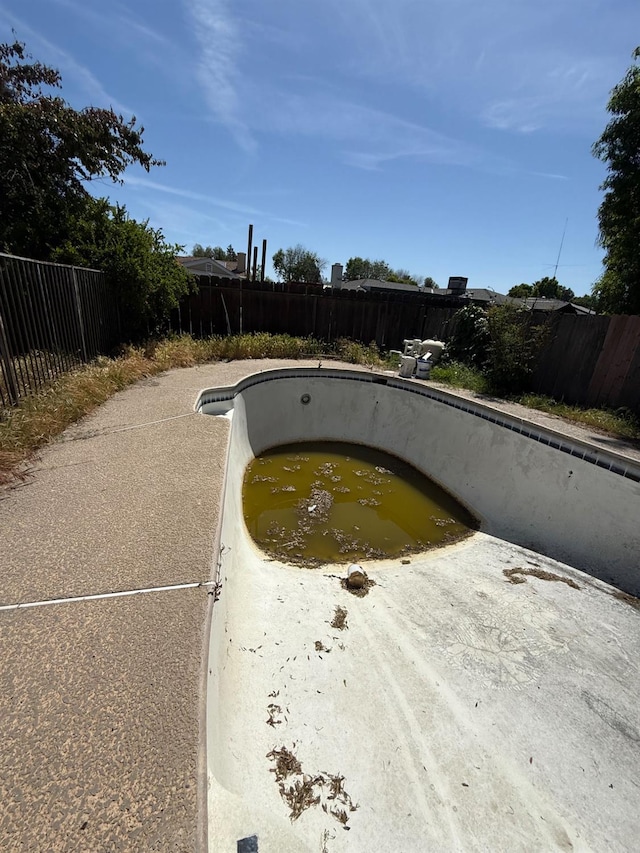 view of pool with a fenced backyard