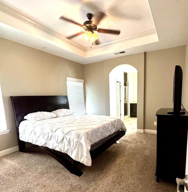 4717 W Joline Dr, Fresno, CA 93722 - bedroom with a tray ceiling, arched walkways, carpet, crown molding, and multiple windows