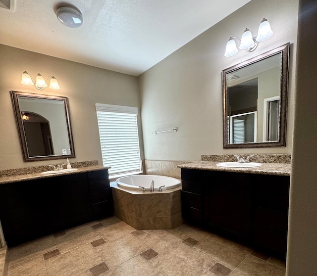 4717 W Joline Dr, Fresno, CA 93722 - full bathroom with two vanities, a garden tub, and a shower stall