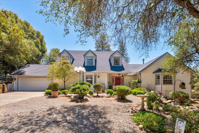 39976 Pierce Lake Dr, Oakhurst, CA 93644 - cape cod-style house featuring an attached garage, driveway, and a shingled roof