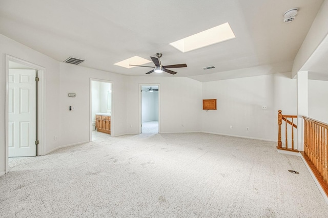 2113 E Portland Ave, Fresno, CA 93720 - spare room with a skylight, ceiling fan, light colored carpet, a smoke detector, and baseboards