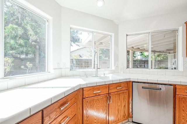 2113 E Portland Ave, Fresno, CA 93720 - kitchen featuring stainless steel dishwasher, a sink, healthy amount of natural light, brown cabinets, and recessed lighting