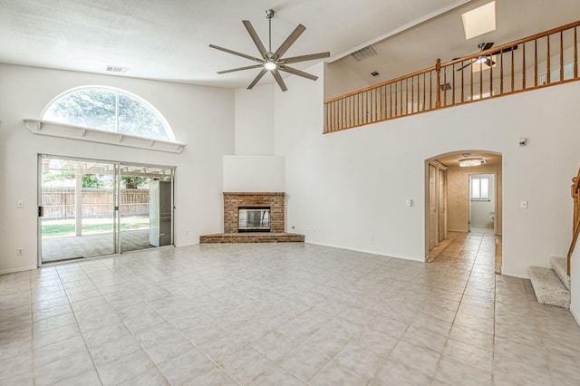 2113 E Portland Ave, Fresno, CA 93720 - unfurnished living room with ceiling fan, high vaulted ceiling, arched walkways, and healthy amount of natural light
