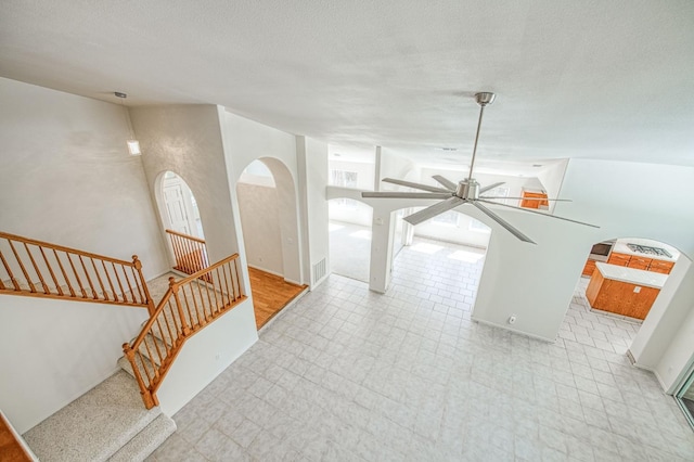 2113 E Portland Ave, Fresno, CA 93720 - interior space with arched walkways, stairs, a ceiling fan, tile patterned floors, and a textured ceiling