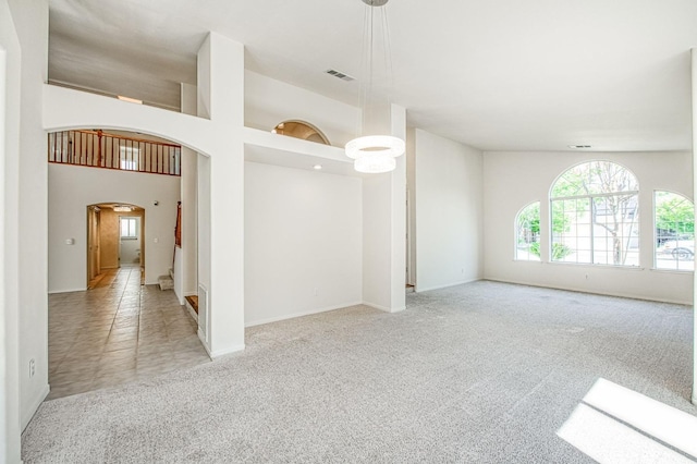 2113 E Portland Ave, Fresno, CA 93720 - spare room with arched walkways, light carpet, and baseboards