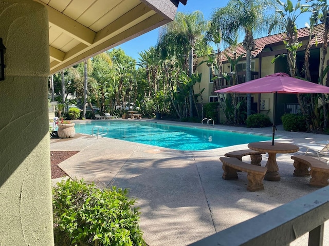 community pool with a patio area