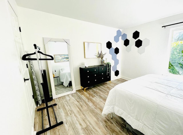 bedroom featuring wood finished floors and baseboards