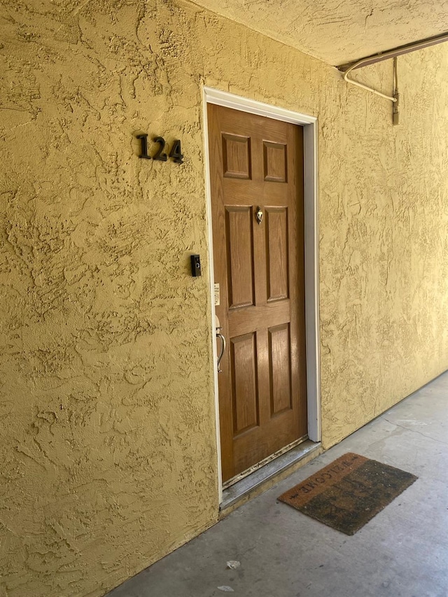 property entrance with stucco siding