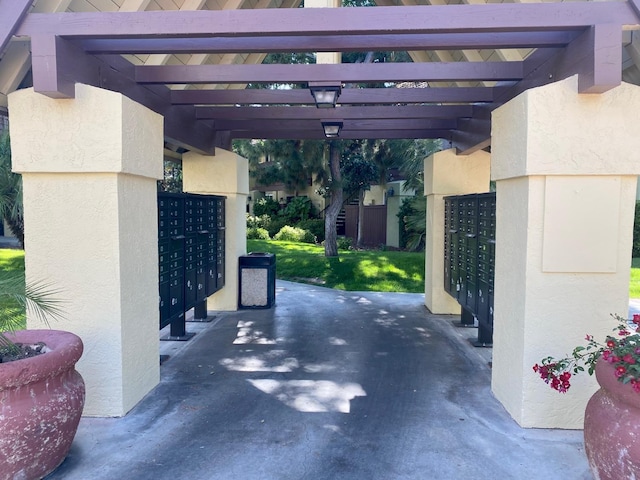 view of parking / parking lot with mail area and a garage