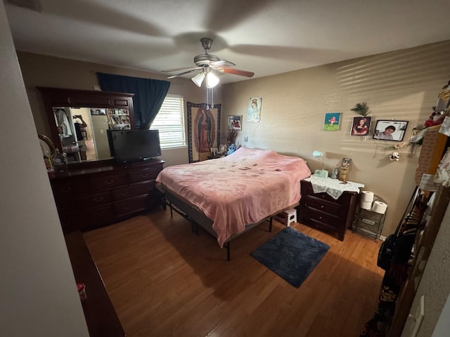 bedroom with wood finished floors and a ceiling fan