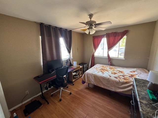 bedroom featuring light wood-style floors and ceiling fan
