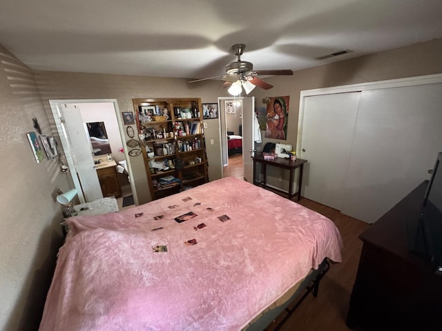bedroom with a closet, wood finished floors, and a ceiling fan