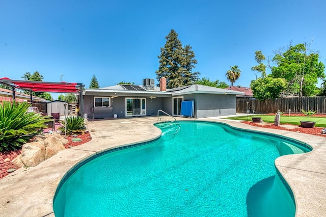 5932 E Illinois Ave, Fresno, CA 93727 - view of swimming pool with a patio area, a fenced backyard, a storage shed, and cooling unit