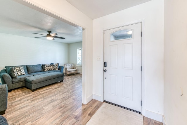 5932 E Illinois Ave, Fresno, CA 93727 - entrance foyer with light wood-style flooring, baseboards, and ceiling fan