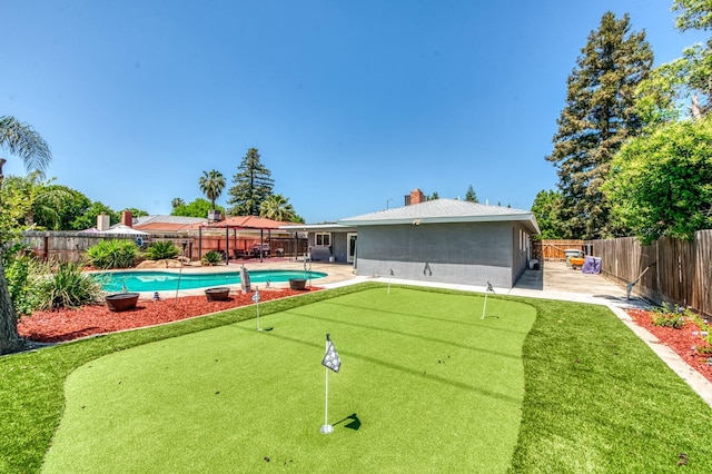 5932 E Illinois Ave, Fresno, CA 93727 - view of swimming pool featuring a putting green, a fenced backyard, and a patio