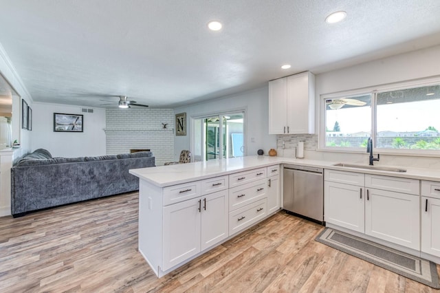 5932 E Illinois Ave, Fresno, CA 93727 - kitchen featuring stainless steel dishwasher, a peninsula, healthy amount of natural light, white cabinetry, and recessed lighting
