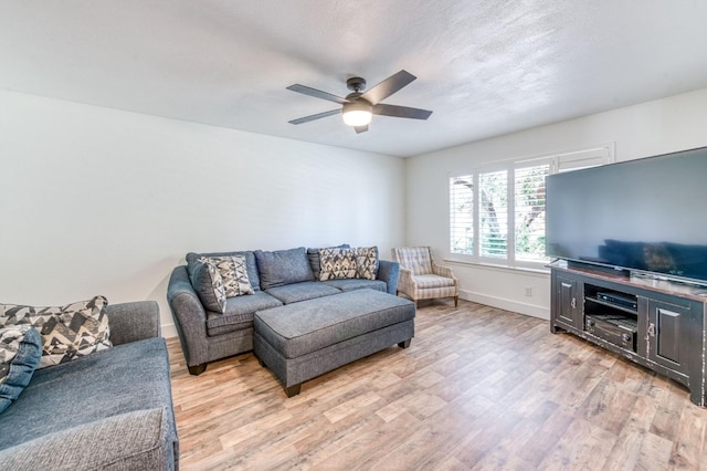 5932 E Illinois Ave, Fresno, CA 93727 - living area featuring light wood-style floors, ceiling fan, and baseboards
