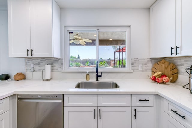 5932 E Illinois Ave, Fresno, CA 93727 - kitchen featuring stainless steel dishwasher, a sink, white cabinetry, tasteful backsplash, and light stone countertops
