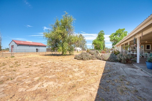 view of yard featuring fence and a patio area