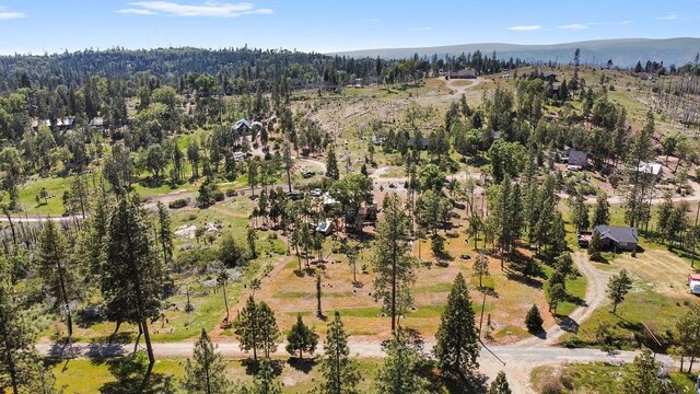 42640 Pinecone Ln, Auberry, CA 93602 - aerial view of property's location with a mountainous background and a heavily wooded area