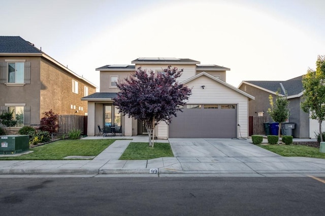 99 N Whittier Ave, Fresno, CA 93727 - view of front of house with solar panels, concrete driveway, and an attached garage
