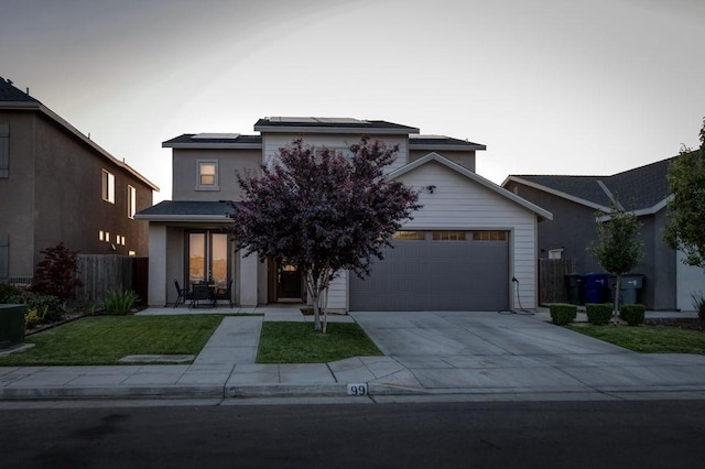 99 N Whittier Ave, Fresno, CA 93727 - view of front of home featuring roof mounted solar panels, an attached garage, and driveway
