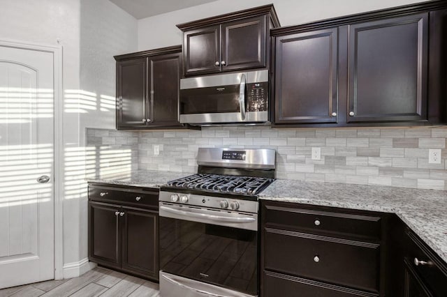 99 N Whittier Ave, Fresno, CA 93727 - kitchen with stainless steel appliances, backsplash, light stone countertops, and dark brown cabinets
