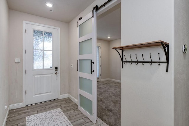 99 N Whittier Ave, Fresno, CA 93727 - doorway to outside featuring baseboards, wood finished floors, a barn door, and recessed lighting