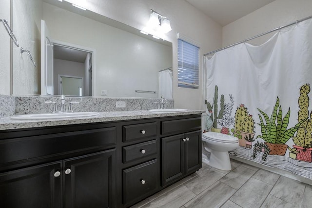 99 N Whittier Ave, Fresno, CA 93727 - bathroom featuring toilet, double vanity, and curtained shower