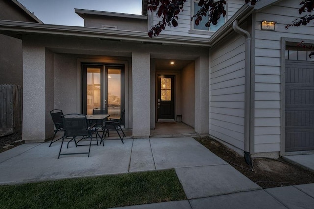99 N Whittier Ave, Fresno, CA 93727 - view of exterior entry with a patio, fence, and a garage