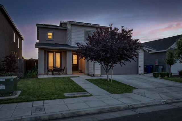 99 N Whittier Ave, Fresno, CA 93727 - view of front of home with concrete driveway, stucco siding, and an attached garage