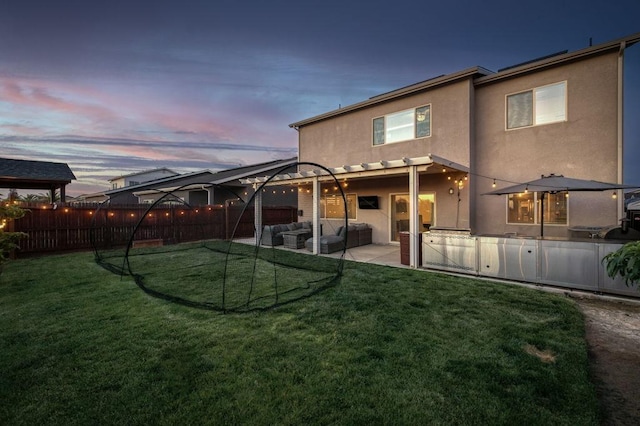 99 N Whittier Ave, Fresno, CA 93727 - back of property at dusk with stucco siding, outdoor lounge area, and a patio area