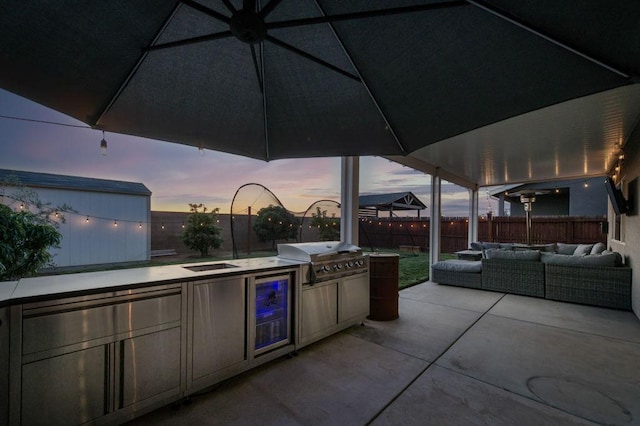99 N Whittier Ave, Fresno, CA 93727 - view of patio featuring an outdoor living space, a grill, exterior kitchen, a fenced backyard, and wine cooler