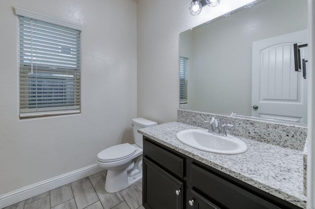 99 N Whittier Ave, Fresno, CA 93727 - bathroom with toilet, vanity, and baseboards