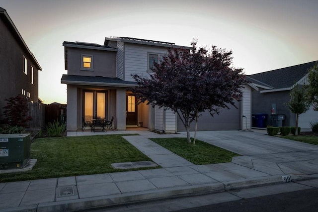 99 N Whittier Ave, Fresno, CA 93727 - view of front of home featuring driveway, stucco siding, and an attached garage
