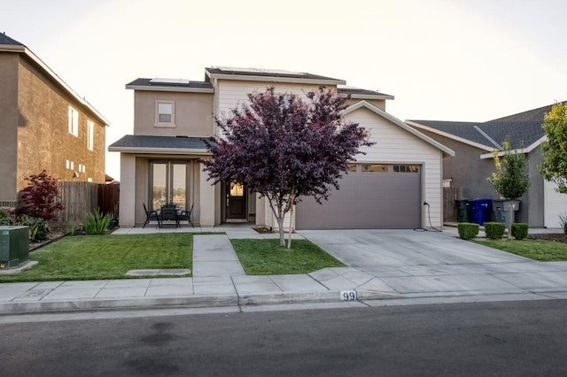 99 N Whittier Ave, Fresno, CA 93727 - view of front of home with solar panels, driveway, stucco siding, a garage, and cooling unit