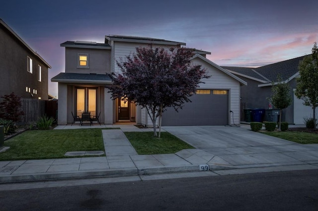 99 N Whittier Ave, Fresno, CA 93727 - view of front facade featuring concrete driveway, an attached garage, and stucco siding