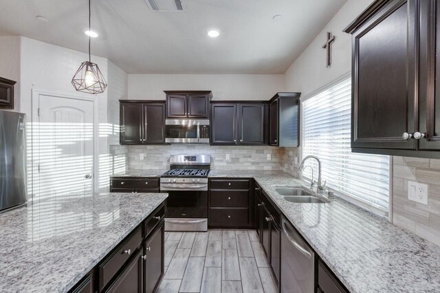 99 N Whittier Ave, Fresno, CA 93727 - kitchen with appliances with stainless steel finishes, a sink, backsplash, and dark brown cabinetry