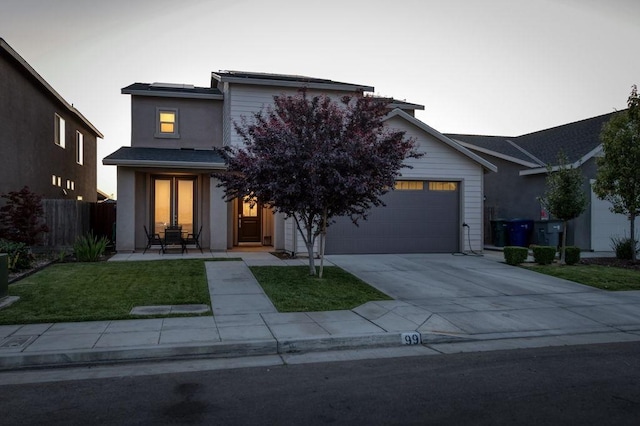 99 N Whittier Ave, Fresno, CA 93727 - view of front of property with driveway, a garage, stucco siding, and solar panels