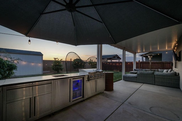 99 N Whittier Ave, Fresno, CA 93727 - view of patio with a grill, outdoor lounge area, a fenced backyard, exterior kitchen, and wine cooler