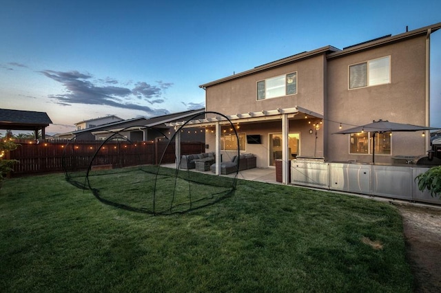 99 N Whittier Ave, Fresno, CA 93727 - back of property with stucco siding, an outdoor living space, and a patio area