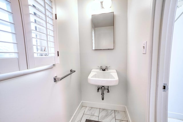 643 Park Ln, Madera, CA 93637 - bathroom featuring baseboards, marble finish floors, and a sink