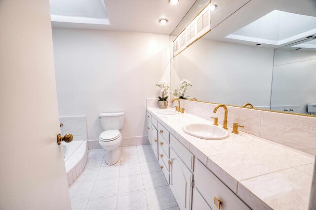 643 Park Ln, Madera, CA 93637 - full bath with toilet, double vanity, tile patterned flooring, tiled bath, and baseboards