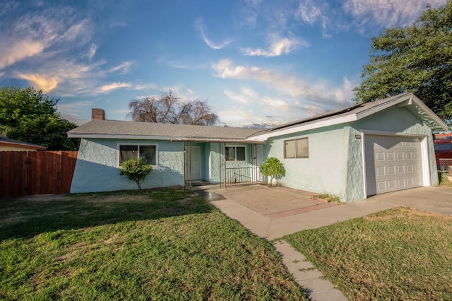 single story home featuring an attached garage, a chimney, solar panels, stucco siding, and concrete driveway
