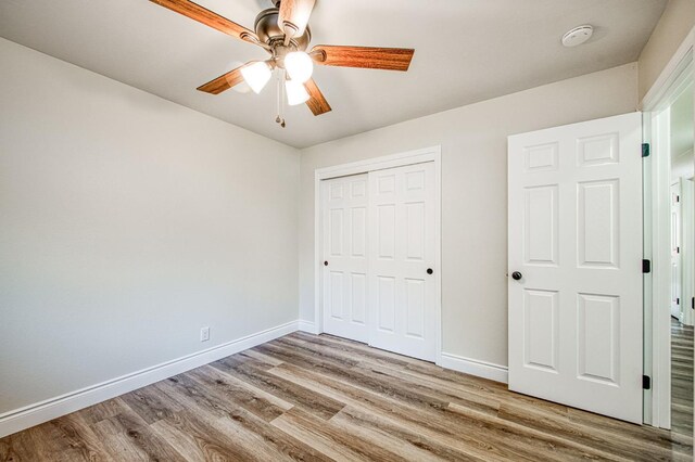 6117 N Colonial Ave, Fresno, CA 93704 - unfurnished bedroom with wood finished floors, baseboards, a closet, and ceiling fan