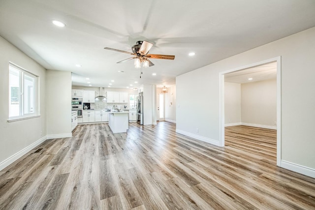 6117 N Colonial Ave, Fresno, CA 93704 - unfurnished living room with ceiling fan, recessed lighting, light wood-type flooring, and baseboards